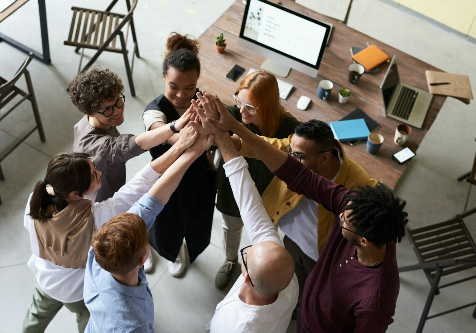 A group of people in a circle giving each other high fives.