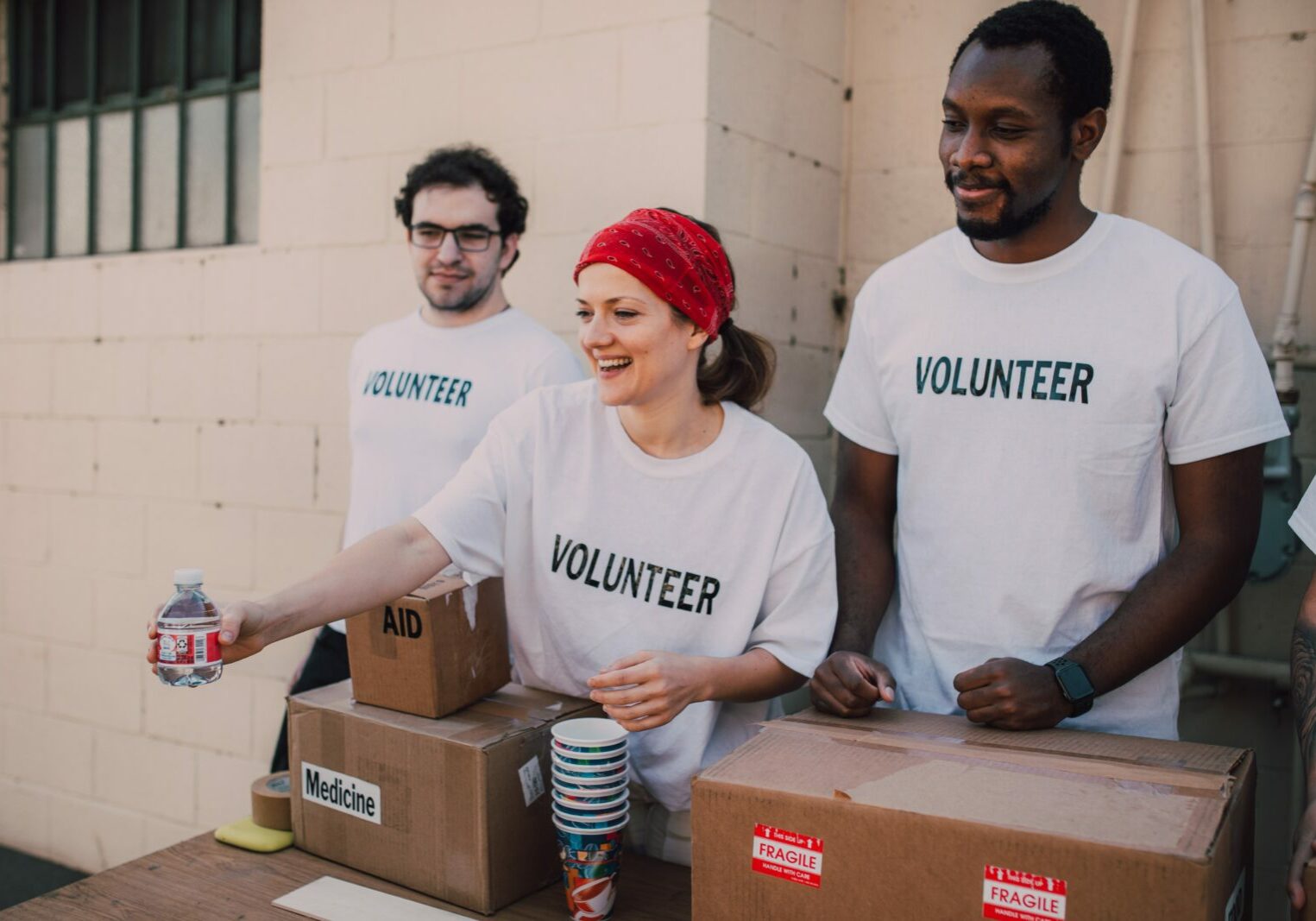 A group of volunteers handing out bottled water.