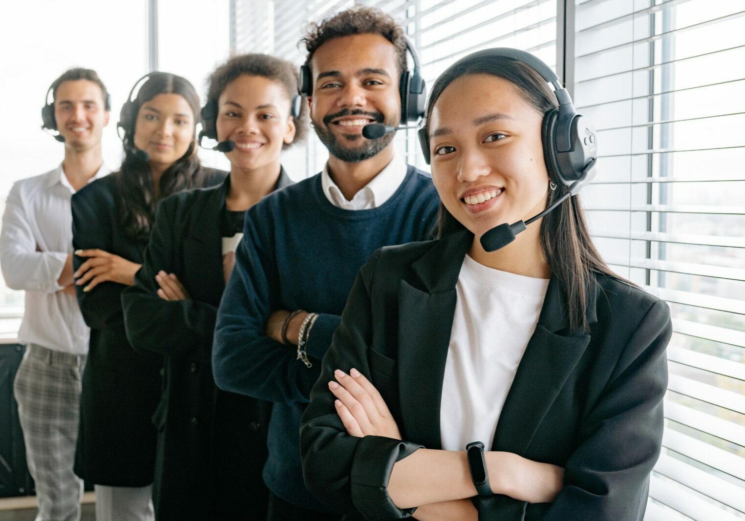 People wearing headsets looking and smiling at the camera.